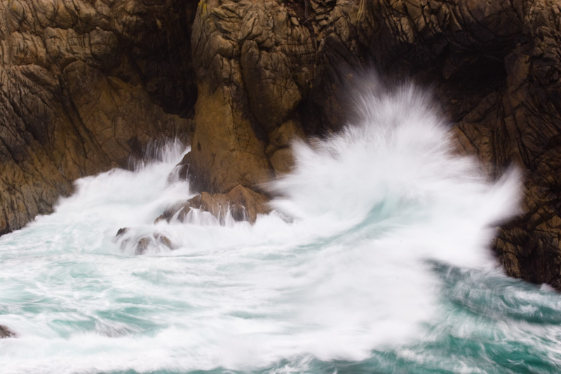 Waves Breaking Against Cliff Face